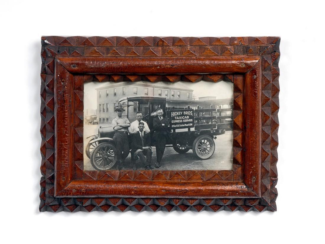 Tramp Art Frame: Title: Tramp Art Frame; Provenance: Tramp art frame with photograph of men with a truck marked, 'Hickel Bros. Taxicab Express Service' In excellent shape with no losses or repairs. Circa 1910. Found i