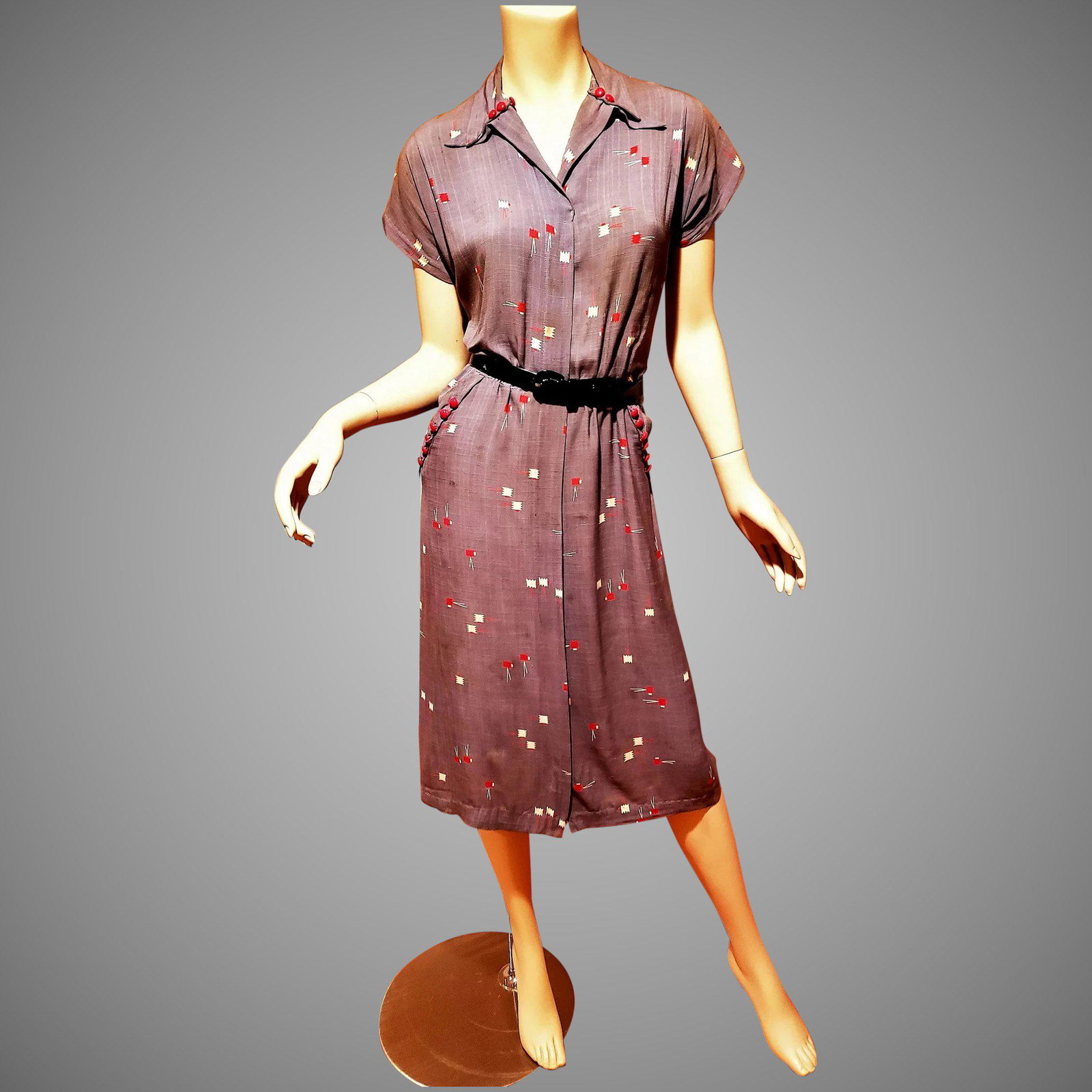 Circa 1940's Grey/Red Linen dress side pockets red: A really beautiful day dress Circa 1940's . Beautiful hand printed design on linen.diagonal open side pockets with red buttons. Front Metal hidden zipper. Has some issues inside the collar the fabric 