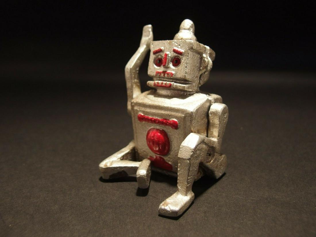 Mini Cast Iron Silver Robert the Robot Toy Paperweight: 2 L x 2.5 W x 3.5 H Great little reproduction cast iron robot. All cast iron, hand painted, slightly distress as shown in the images. Certainly looks old! This looks alot like the mechanical coin bank