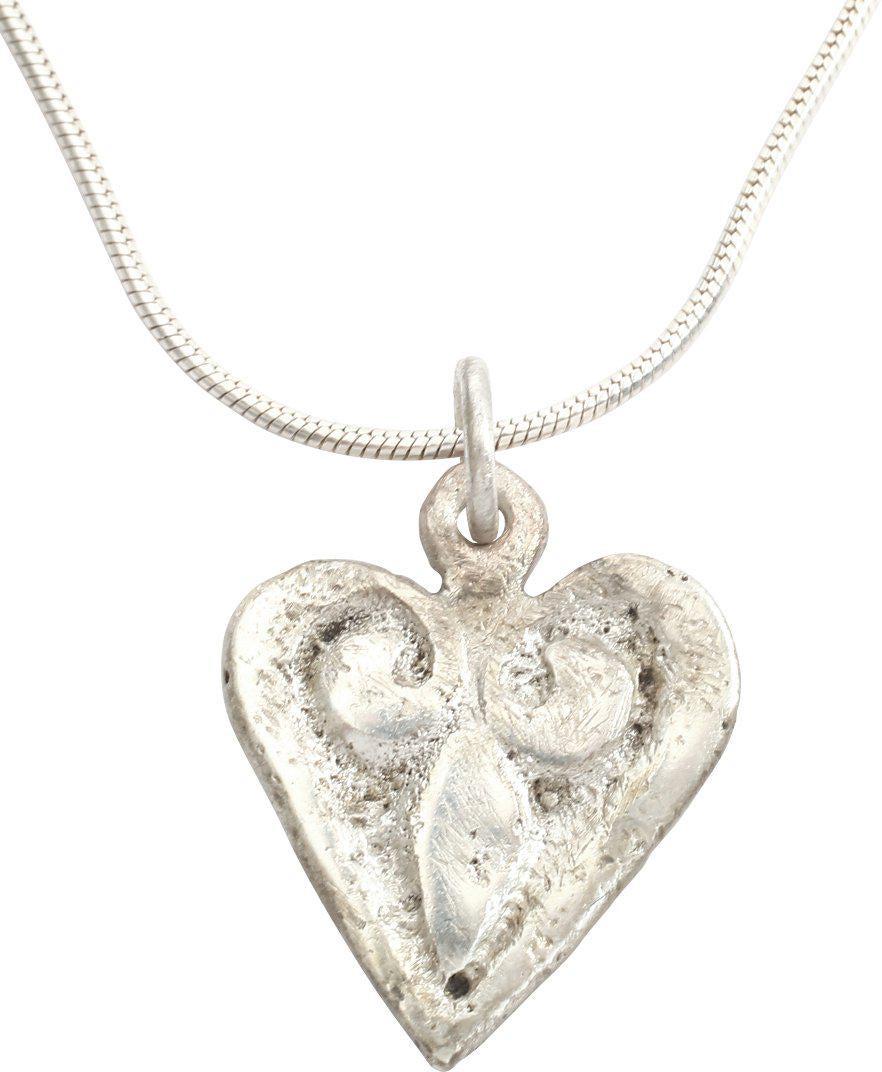 VIKING HEART PENDANT C.900-1000 AD: Early example of the fully evolved form with cusped top. Slightly domed intricate curvilinear trefoil infill as favored by Vikings. Petite size, just over 3/4” height. The heart stood for bravery, f