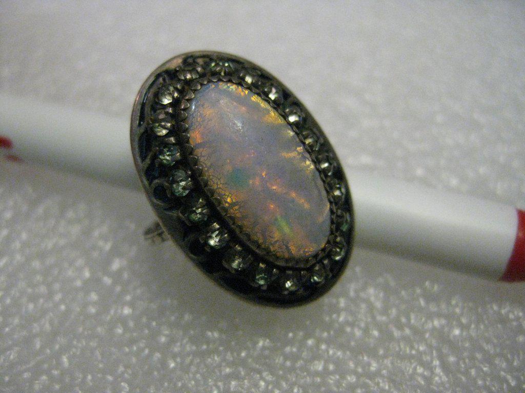 Vintage Sterling Opal Southwestern Ring, Rhinestone: Vintage beauty of a faux opal ring, appears to be a Slocum Opal which is a manufactured opal but very nice it is oval and domed nicely The stone is 3/4" long and 1/2" wide and the ring it itself is 1"