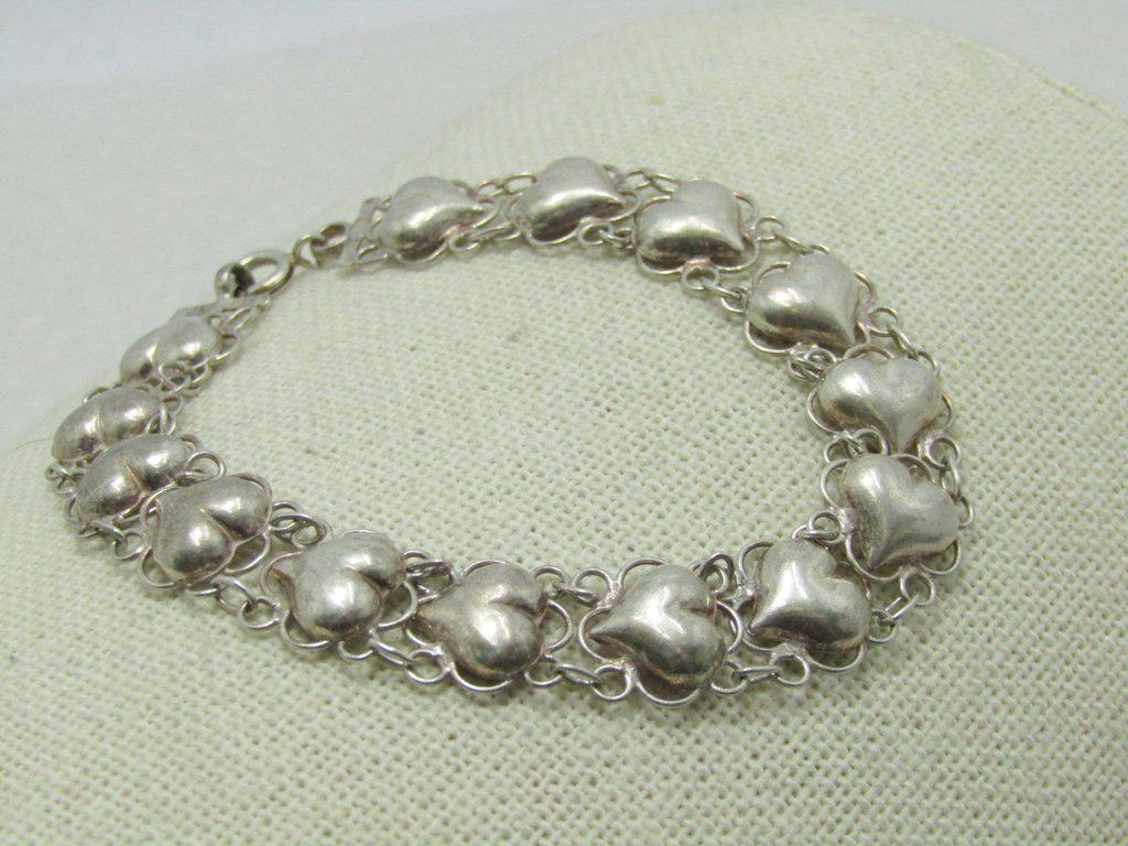 Vintage Sterling Filigree Heart Bracelet, 7.5", Puffy: Vintage Sterling Puffy Heart Bracelet - wide open chain with a filigree effect. Itis 7.5" long and 11mm wide - each link has a puffy 1/2" heart in the center. Weight is 7.82 grams. It is signed ND. Ag