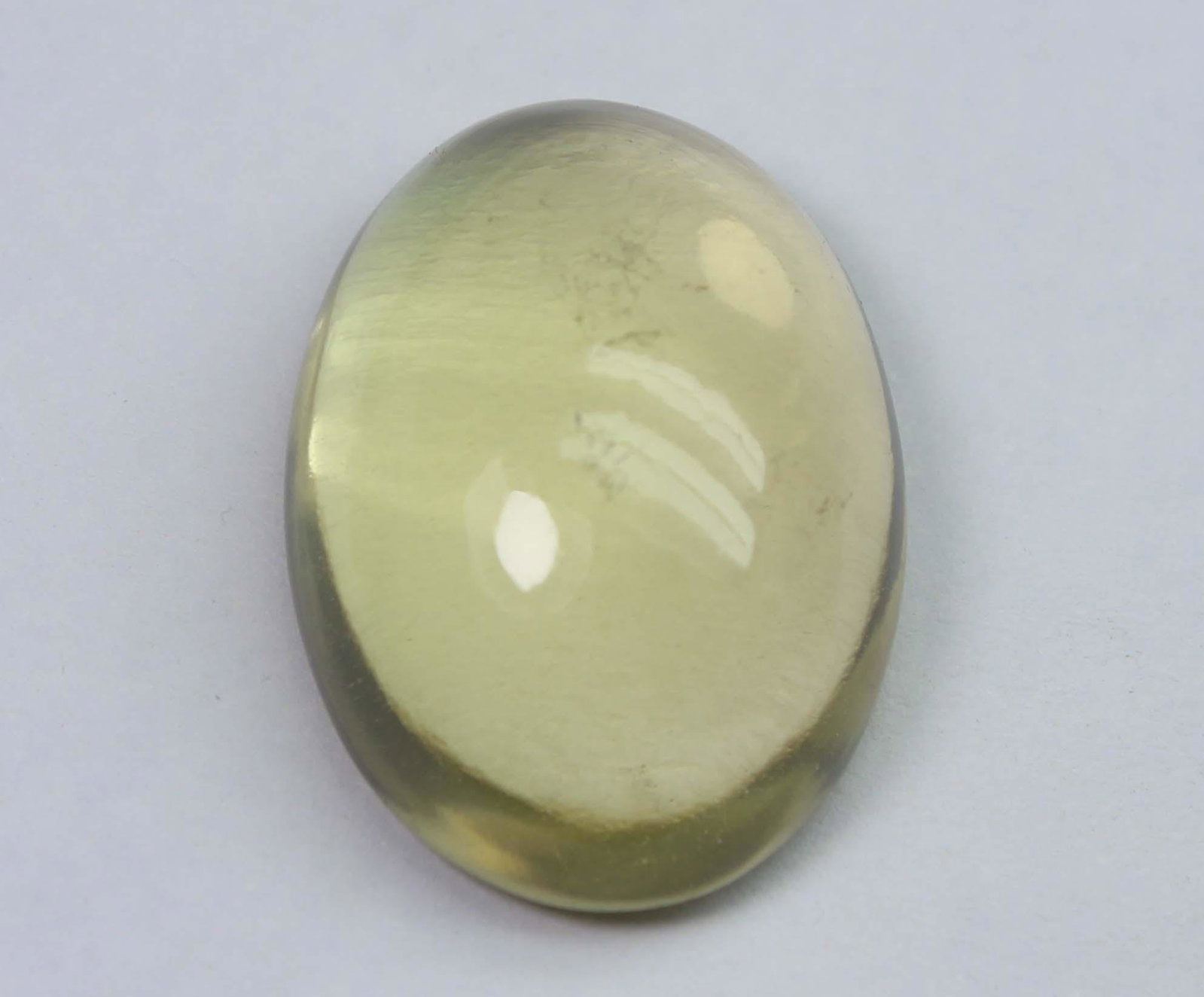 22.02 Cts Natural Lemon Quartz: No Reserve! Title: 22.02 Cts Natural Lemon Quartz Additional Information: Gemstone : Natural Lemon QuartzWeight : 22.02 CtsShape : Oval CabuchonColour : Greenish Yellow Dimensions : 22x15.8x8.9 mmOrig