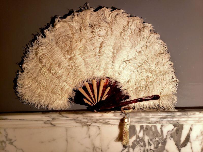 Antique Ostrich Feathers Hand Fan Tortoise shell: This one is very Rare it is from the late 1920's 30's . Never used still with paper covering the inserts. Hand made Tassel and embroidery. It is quite Large and a stunning Piece of History . Came from