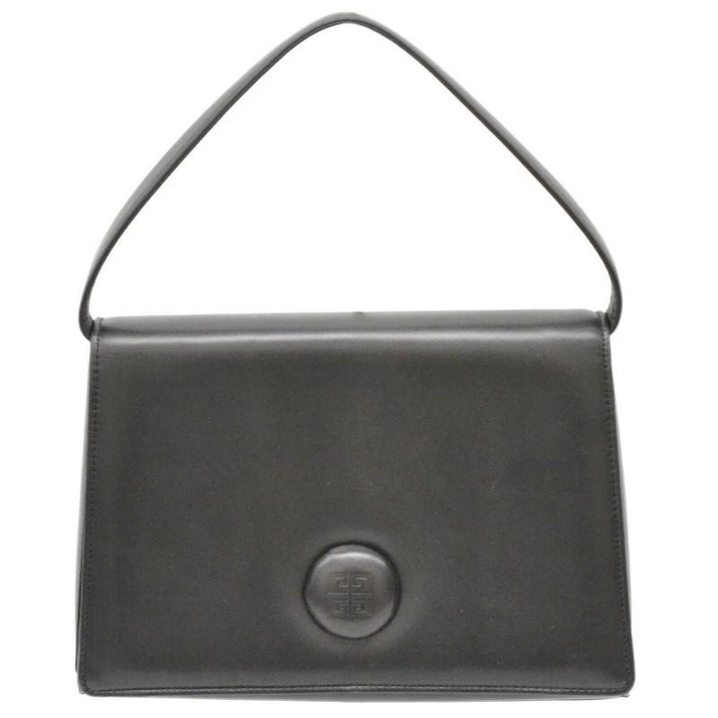 Givenchy Vintage Handbag: Brand: Givenchy Model: Vintage Handbag Color: Black Material: Leather Dimensions: W 24 x H 16.5 x D 6 cm Serial number: NA Inclusions: Tag, Spare Button only Country of origin: Unknown Condition