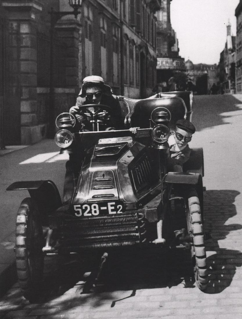 J. H. LARTIGUE - Zissou & Lartigue in a De Dion, Rue: Artist: J. H. LARTIGUE Print Title: Zissou & Lartigue in a De Dion, Rue Cortambert,1903 Medium: Photo-lithograph Printed 1990’s in France Image size (inches) approx. 10 x 8” Jacques Henri Lartigue
