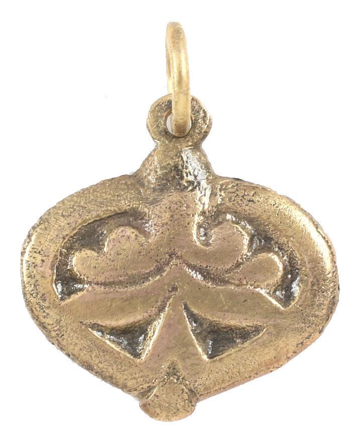 ANCIENT VIKING HEART PENDANT NECKLACE 900-1050 AD: Just over ¾” height including the loop, made by the open face mold method with a broad border and bottom nub. The field with an incised trefoil topped by the scrolling terminals of the broad border