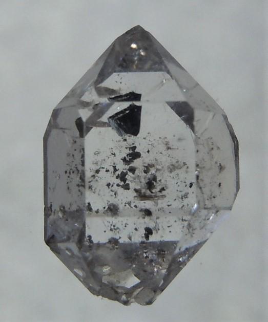 VERY CLEAR, GENUINE HERKIMER DIAMOND: Title: VERY CLEAR, GENUINE HERKIMER DIAMOND Origin: Ace of Diamonds Mine, Middleville ,New York, USA Size: 0.9x0.6x0.45 cm / 0.36 gram Description: clear quartz var herkimer diomond with black hydroca