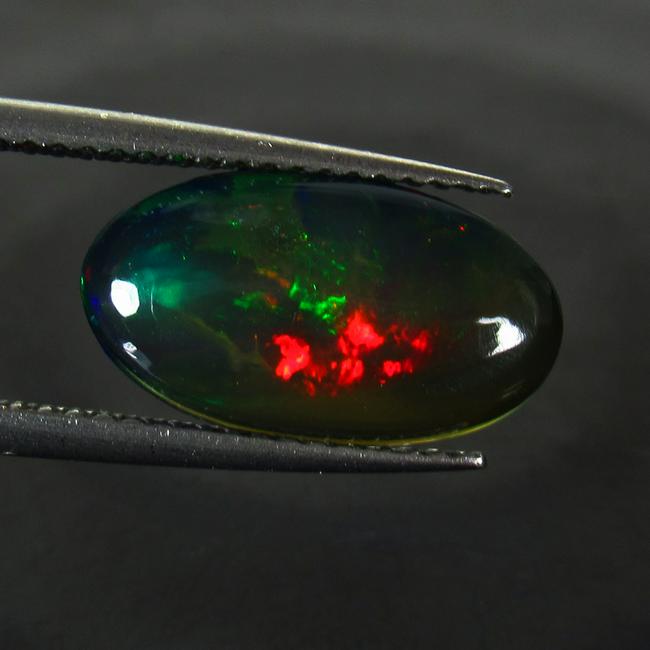 1.95 Ct Natural Ethiopian Fire Black Opal Oval Cab: Title: 1.95 Ct Natural Ethiopian Fire Black Opal Oval Cab Stone Clarity: Translucent Gemstones: Natural Black Opal Carat Weights: 1.95 Size/Dimensions: 15.00 x 8.40 x 3.40 mm Additional Information: N