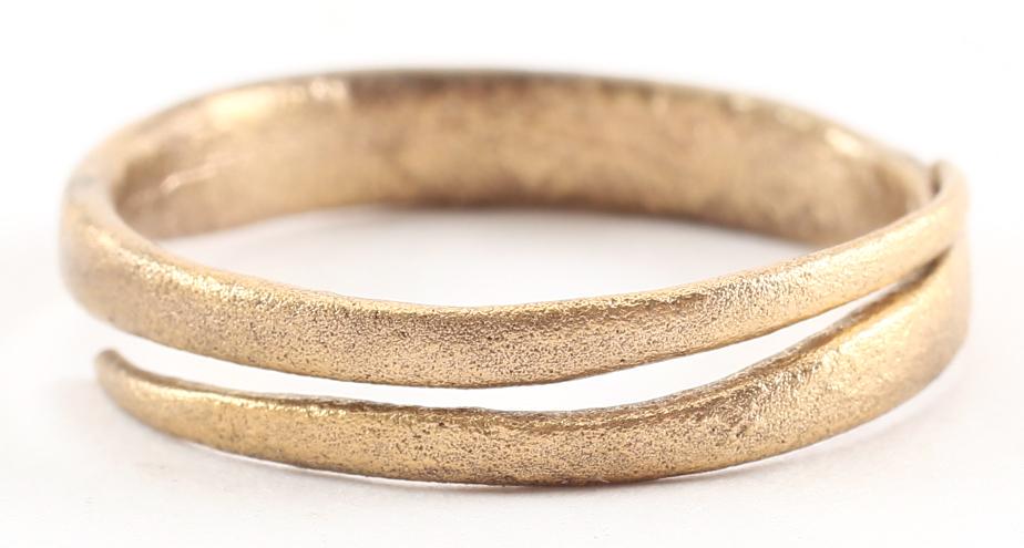 VIKING WEDDING RING 10th-11th CENTURY SIZE 7 ¾ .: Gilt bronze, size 7 ¾ -8. Rounded band, 2.8mm width. Cast with a central core which was laboriously removed to finish the ring for wear. The inside with remnants of the core and distinct tool marks f