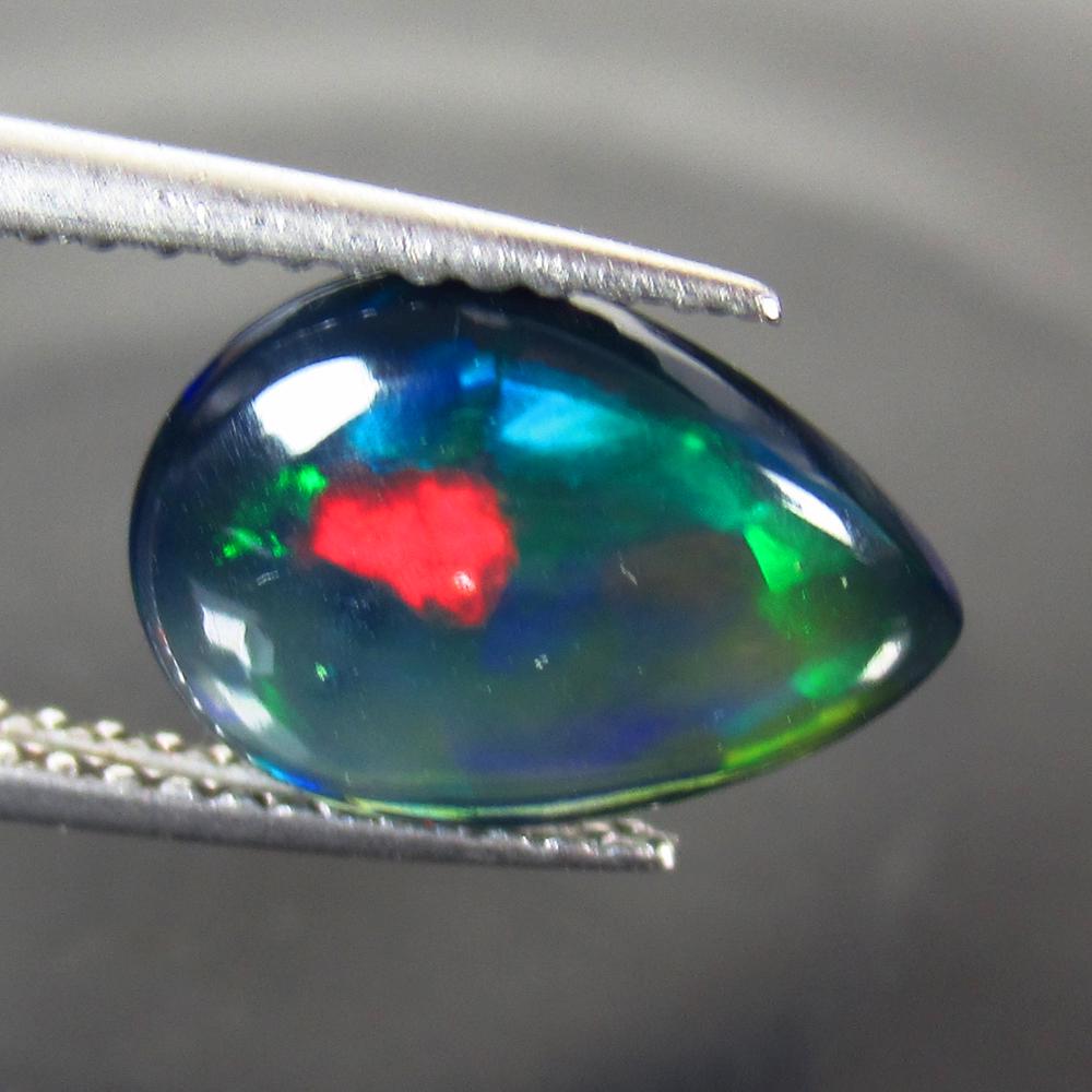 1.66 Ct Geuine Ethiopian Fire Black Opal Pear Cab: No Reserve! Title: 1.66 Ct Geuine Ethiopian Fire Black Opal Pear Cab Color/Clarity: Translucent Gemstone: Natural Black Opal Carat Weight: 1.66 Size/Dimensions: 11.90 x 3.80 x 8.00 mm Additional Infor