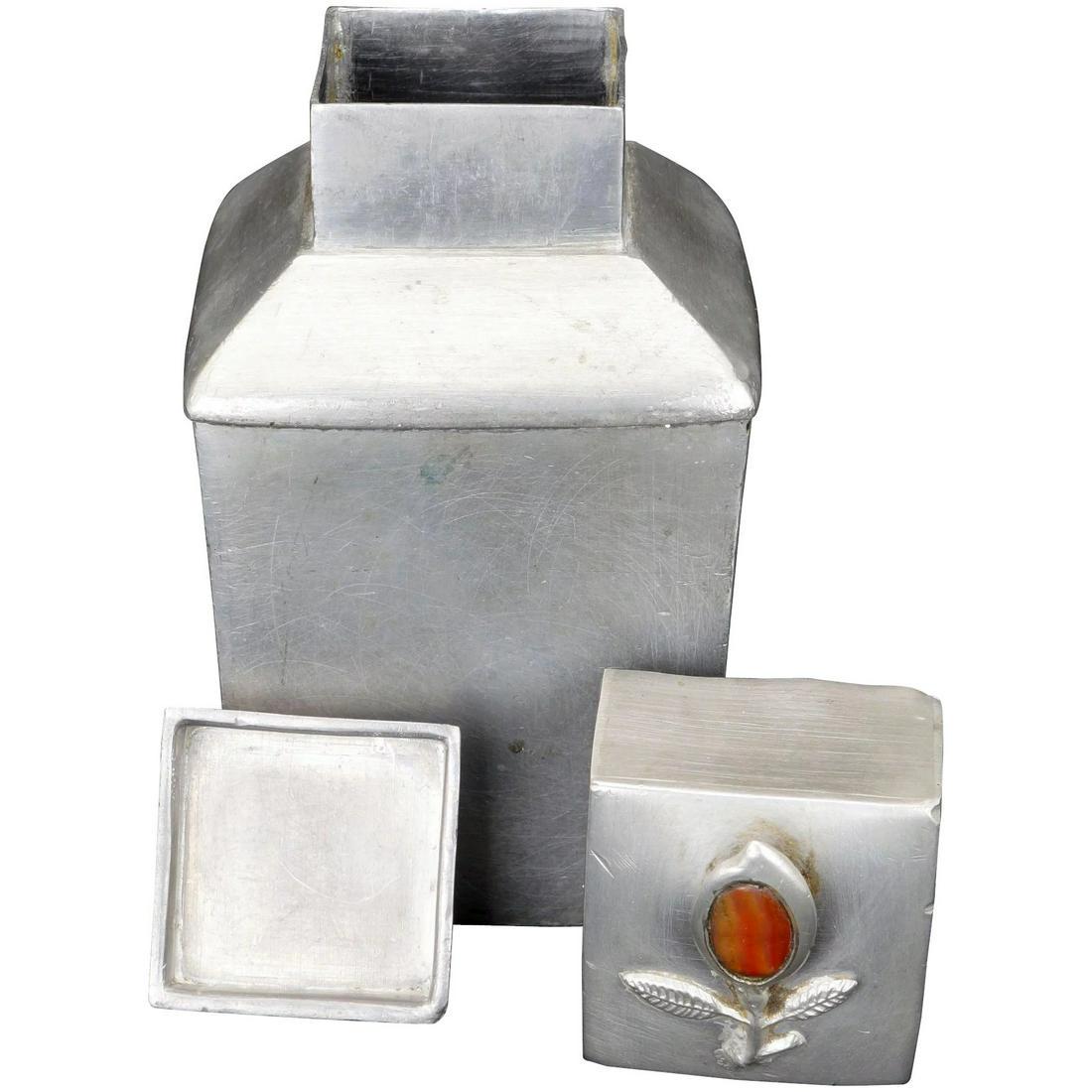 Chinese Metal Tea Caddy Carnelian Finial c 1900: Rectangular tea caddy that is stylish in its simplicity. The single adornment is the flower finial on the lid with just a dash of colorful carnelian stone. A small rectangular mixed metal alloy contai