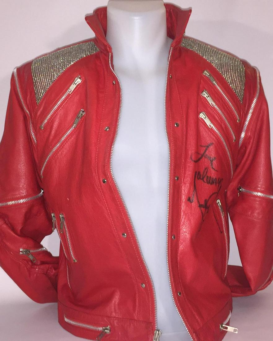 Beat it jacket signed by Michael Jackson: Title: Beat it jacket signed by Michael Jackson Provenance: A vintage red leather "Beat It" style jacket with the signature metal mesh shoulder patches and decorative zippers. The jacket is signed and