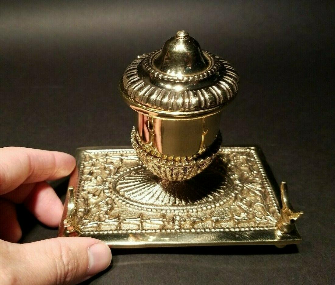Brass Pen Holder Inkwell Desk Stand: 4 1/4" Tall x 2" wide Nice reproduction of an antique pen holder. This piece is all solid brass, well made! Notice the prongs to hold a pen. Good quality for any early home decor for use or display. B