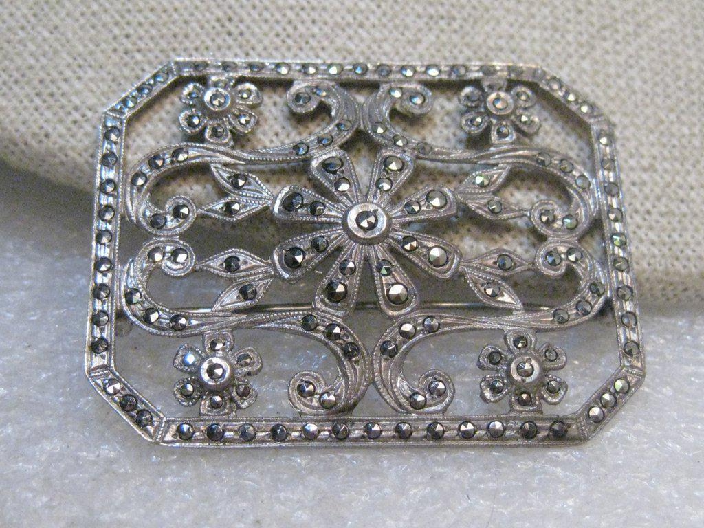 Vintage Sterling Marcasite Floral Brooch, 1930's/1940's: Vintage Sterling Marcasite Floral Brooch, 1930's/1940's - rectangular shaped with angled corners, floral design that has raised and curved areas and a cut-out design. It is 1-7/8" by 1.5". Weight is 1