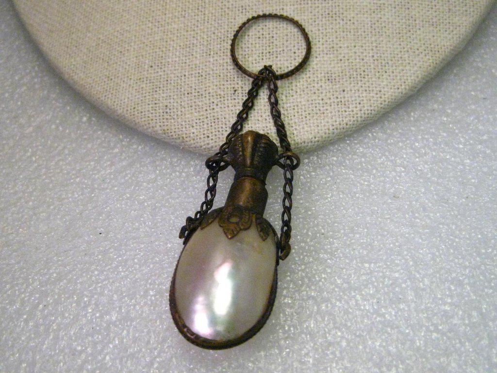 Antique and true vintage Shell Chatelaine from the mid: Antique and true vintage Shell Chatelaine from the mid to late 1800's. This is a shell vessel capped with french brass framing, chains, cap with cork and a ring to slip on a finger. These would attach