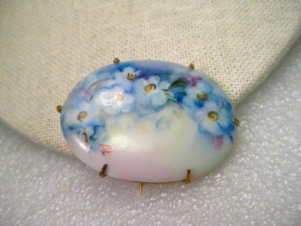 True Vintage Victorian Hand Painted Blue and White: True Vintage Victorian Hand Painted Blue and White Forget-me-not delicate flowers on this oval porcelain brooch that is 1.75" by 1.25". It has a gold tone backing with the pin that extends beyond the