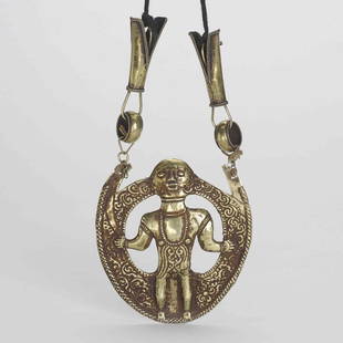 A GOLD ATUF PENDANT: A GOLD ATUF PENDANT; Atuf, the solar hero and great hunter is seated upon a Hindu styled throne with hands outstretched. He is supposed to have sailed from the west and brought new technologies with