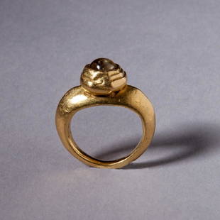 Gold and Crystal Ring: Gold and Crystal Ring; A gold ring with a tumbled crystal inset in a high collar. Reserve: $4,800.00 Shipping:Domestic: Flat-rate of $35.00 to anywhere within the contiguous U.S.International: