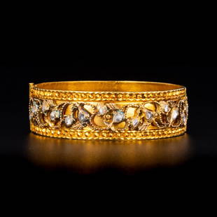 Gold and diamond bangle: Gold and diamond bangle; A rigid gold bangle inset with rose-cut intan diamonds set in silver within a border of gold granulation. Reserve: $4,400.00 Shipping:Domestic: Flat-rate of $35.00 to