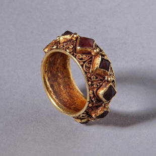 Gold and Garnet Ring: Gold and Garnet Ring; An unusual ring decorated with square garnets standing proud of a finely filigreed shank. Reserve: $6,500.00 Shipping:Domestic: Flat-rate of $35.00 to anywhere within the
