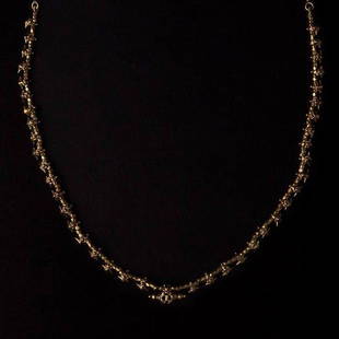 Gold Bead Necklace: A solid gold bead necklace made up of very small tavi’z interspersed with gold beads. A larger tavi’z is in the center of the necklace. Reserve: $3,000.00 Shipping:Domestic: Flat-rate of $35.00