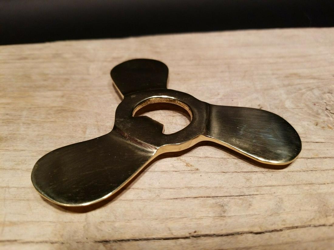 Brass Propeller Bottle Opener: 4" wide Great old style brass propeller bottle opener. Nice solid brass piece shaped like a boat propeller. Reserve: $15.00 Shipping: Domestic: Flat-rate of $6.00 to anywhere within the contiguous U.S