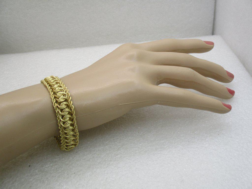 Vintage 10kt Rope & Woven Bracelet, 7.75", 13mm, 7.28: 10kt Gold Rope & Woven Bracelet, 7.75", 13mm, 7.28 grams. Signed AAJ. Appx. 1980's. Wide at 13mm (1/2", with the frame being 2.7mm wide twisted rope chains and the center a triple link weave that is p