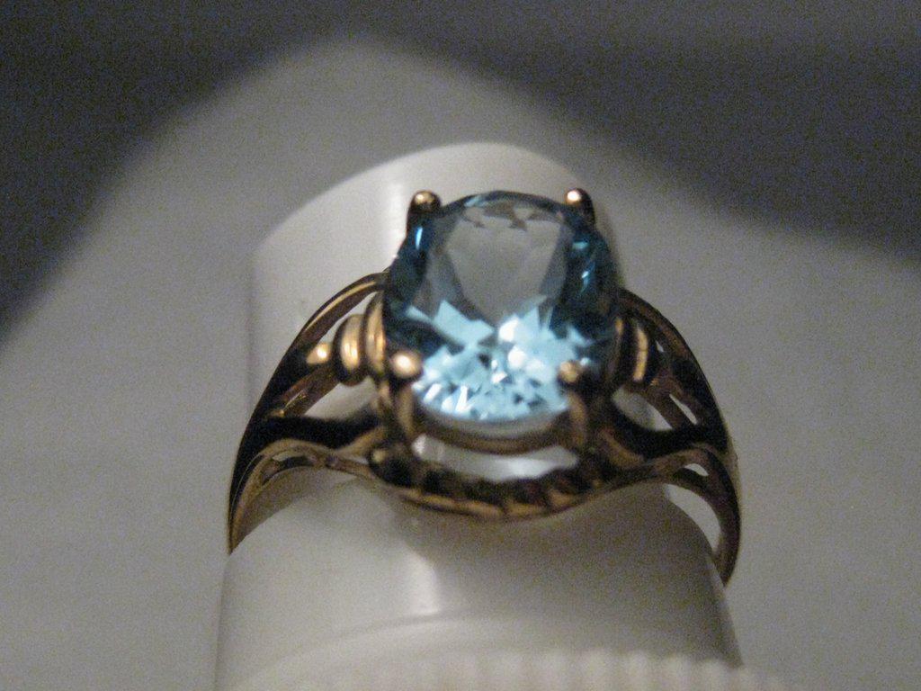 Vintage 10kt Blue Topaz Ring, Art Deco Themed, SZ. 7,: Vintage 10kt Blue Topaz ring, appx. 2.25 TCW - art deco themed, size 7. It has a stone that is appx. 8.9mm by 6.9mm - it cannot be measured exactly due to setting. It has an ornate art deco style sett