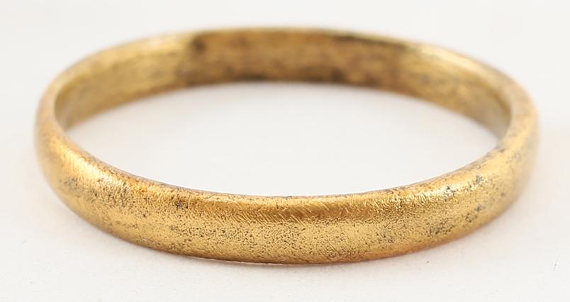 VIKING WOMAN’S WEDDING RING, S6 1/2. 9th- 11th CENTURY: Gilt bronze, size 6 1/2. 2.4mm width band with rounded face. Surface lightly textured from burial. Vikings exchanged rings on the pommel of the groom’s sword. Professionally refurbished with the 24k