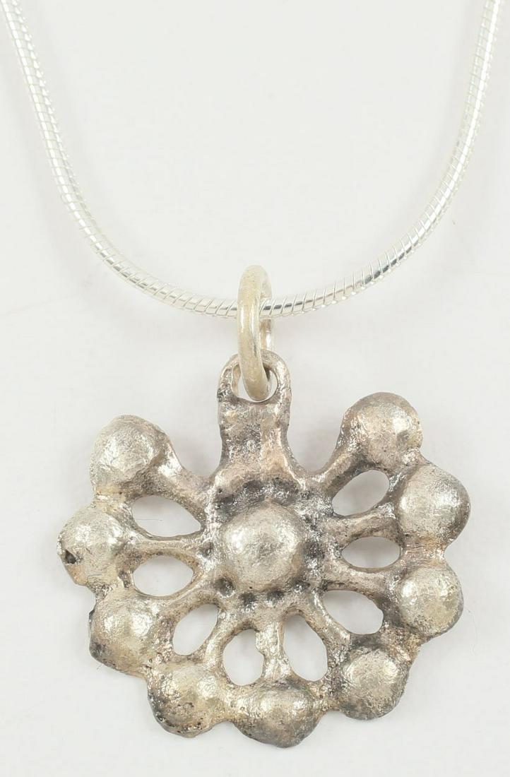 MEDIEVAL WOMAN’S PENDANT, 10th-12th CENTURY.: Crusades period. Over 3/4Â”, comprising a radial splay of hemispheres on stalks, probably a late reference to the Roman Rota Fortuna (Wheel of Fortune). That was the symbol for Fortuna and embodied