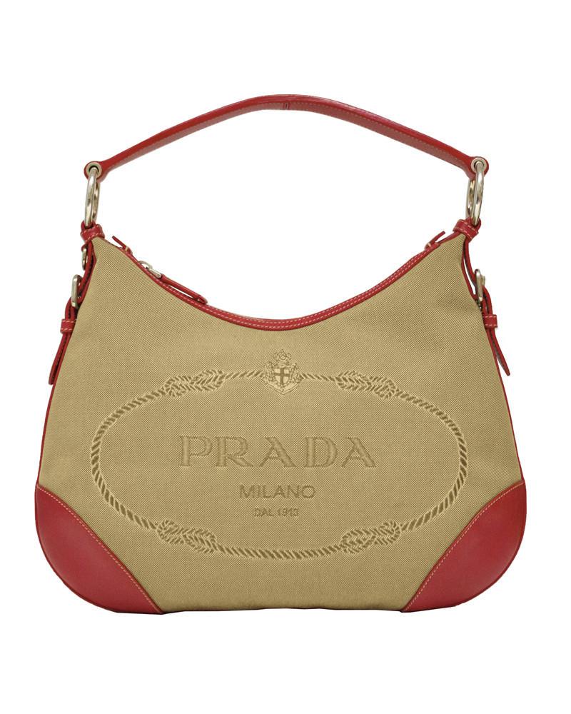 Prada Hobo Bag with Red Trimming: Early 2000’s Prada jacquard hobo style bag with red leather trim. The zip top bag feathers a large crested PRADA MILANO logo woven into the face and is finished with silver hardware. Single zippered