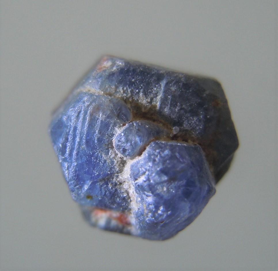 3.3 CT HEXAGONAL SAPPHIRE CRYSTAL CLUSTER: Title: 3.3 CT HEXAGONAL SAPPHIRE CRYSTAL CLUSTER Origin: Zazafotsy Quarry, Ihosy Dist. Ihorombe, Madagascar Size: 0.67x0.67x0.66 cm / 0.66 gram Description: complex hexagonal blue sapphire crystal clu