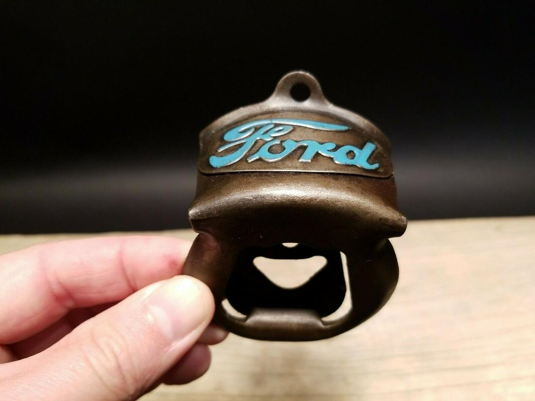 Ford Beer Bottle Cap Opener: 3 1/4" tall x 2 3/8" wide Wonderful Ford motors wall mount bottle cap opener. Well made all metal opener comes with mounting screws! Reserve: $20.00 Shipping: Domestic: Flat-rate of $8.00 to anywhere 