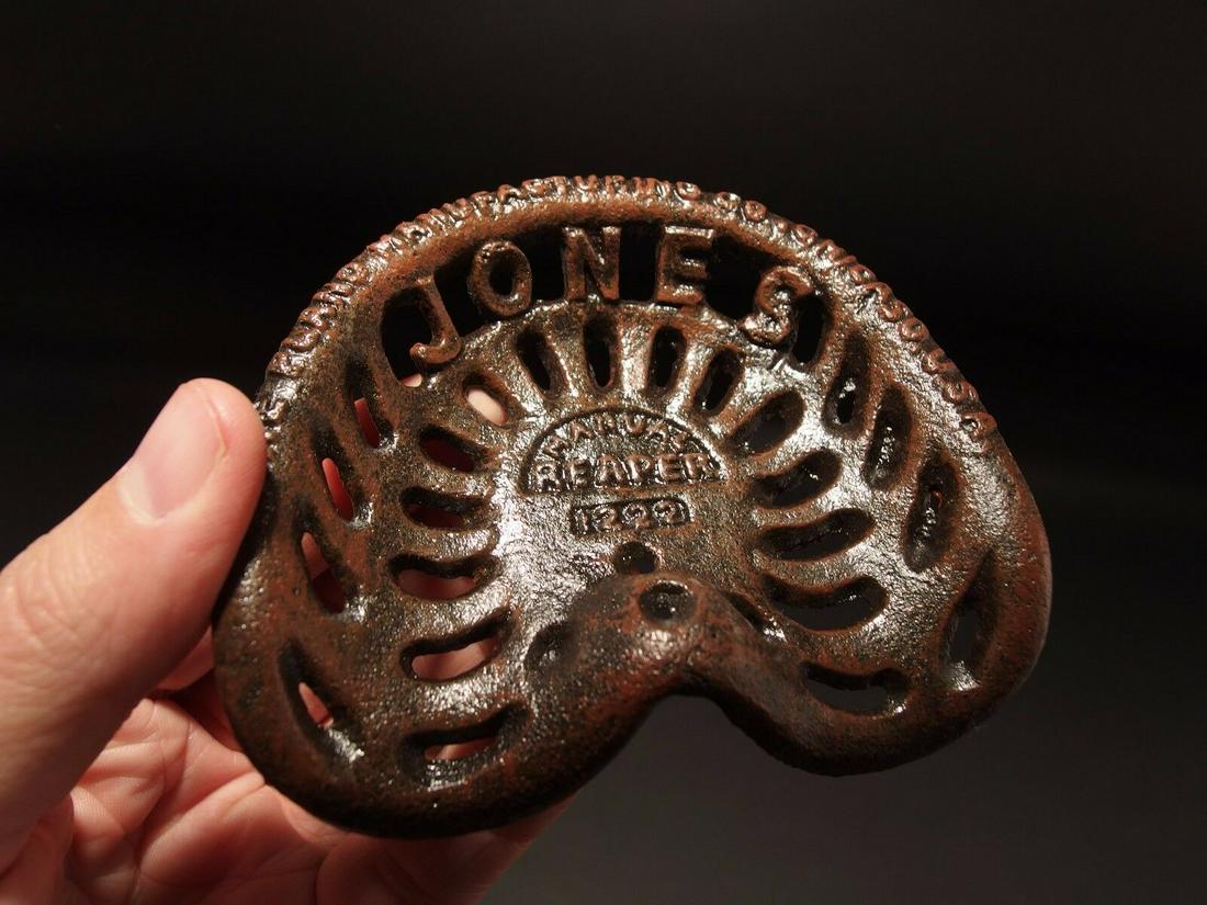Miniature JONES Cast Iron Farm Tractor Seat Paperweight: 4 1/8" x 3 1/2" Great reproduction antique folk art cast iron tractor seat. This piece was cast to look just like the larger version likely as a salesman sample. Makes a great paperweight for any coll