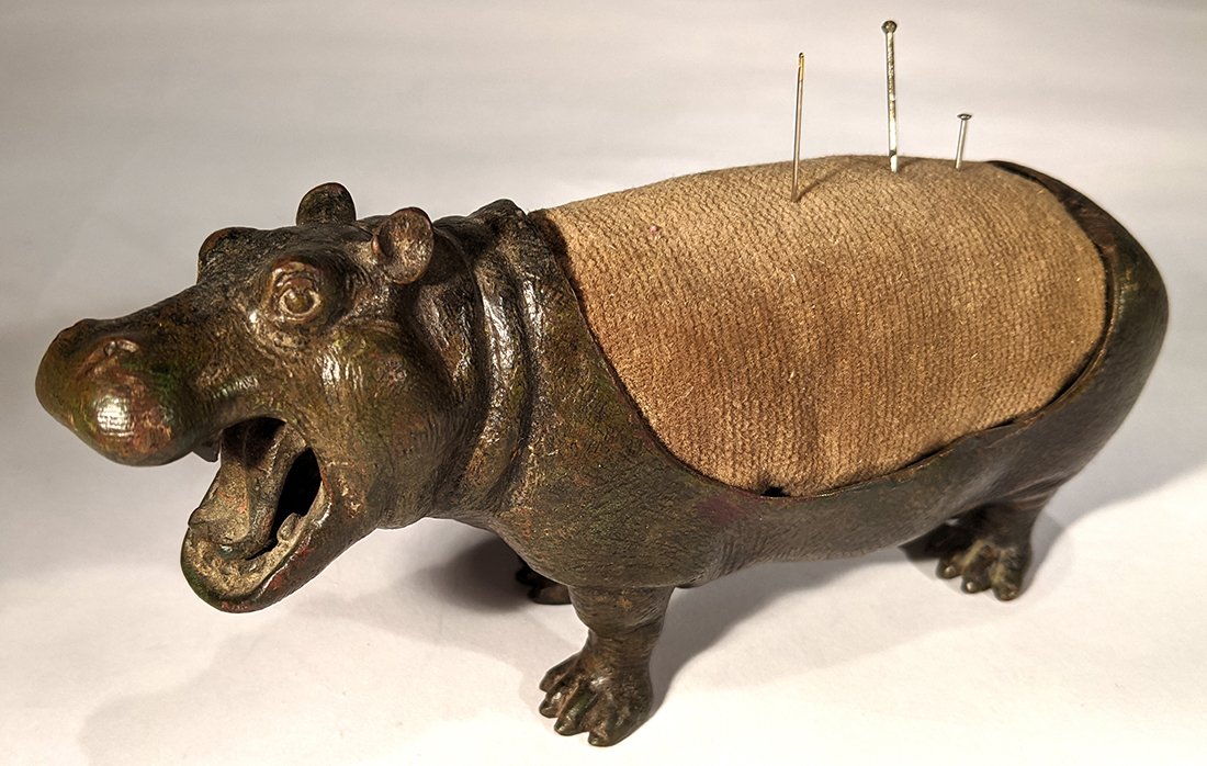 Bronze HIPPO: Title: Bronze HIPPO Date: 1870 Origin: French Dimension: 2 1/2" H x 9" W Provenance/Additional Info:Rare painted bronze Hippopotamus with pin cushion on its back Shipping: Domestic: Flat-rate of $30.0