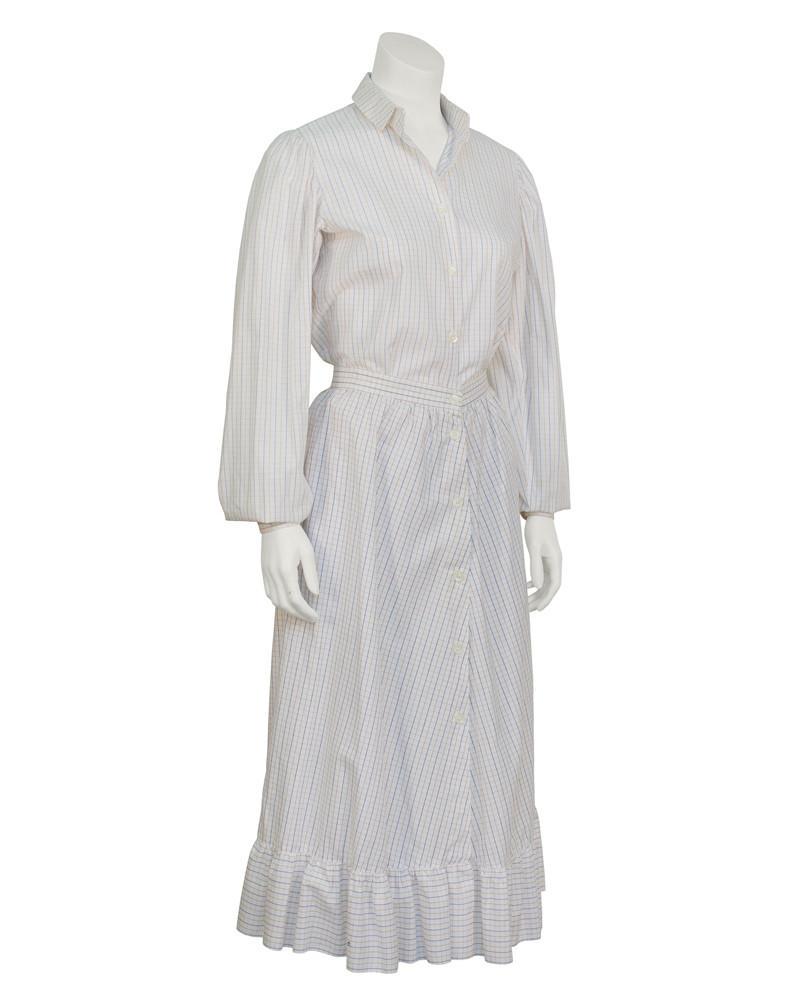 Anne Klein White Cotton Skirt Ensemble: Early 1970's Anne Klein prairie/western style cotton skirt and shirt ensemble in an allover brown and navy window pane oxford cloth. The barrel style sleeves with slight gathering at the shoulder butt