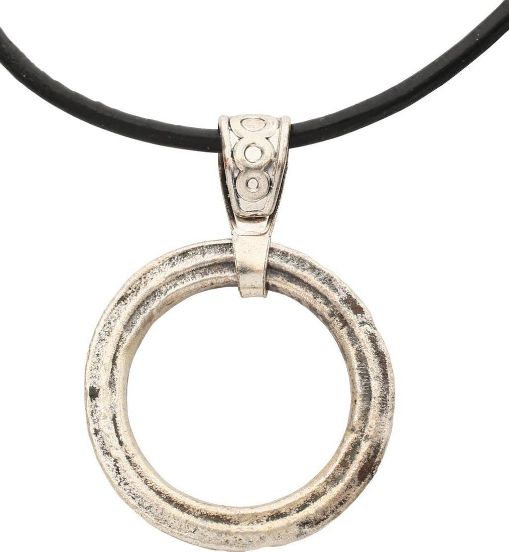VIKING PROTECTIVE BROOCH PENDANT 10th-11th CENT JEWELRY: Rare example, circular bronze, just under 1” diameter. Each face with triple ridges forming the surface. The surface with very light texture from burial. Professionally conserved and the silver surf