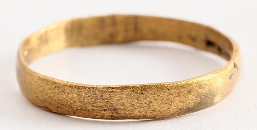 VIKING WEDDING RING 10th-11th CENTURY SIZE 7 ¾ .: Gilt bronze, size 7 ¾ -8. Rounded band, 2.8mm width. Cast with a central core which was laboriously removed to finish the ring for wear. The inside with remnants of the core and distinct tool marks f