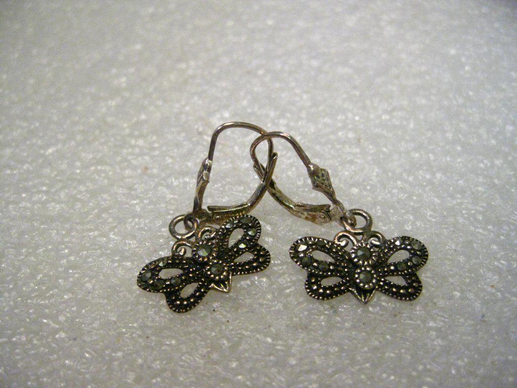 Sterling Silver Butterfly Marcasite Lever Back Pierced: Sterling Silver Dangling Butterfly Pierced Earrings with lever back fish hook posts. They have marcasite accents in varying sizes. Total weight for both earrings is 2.71 grams. They are 1" long from t