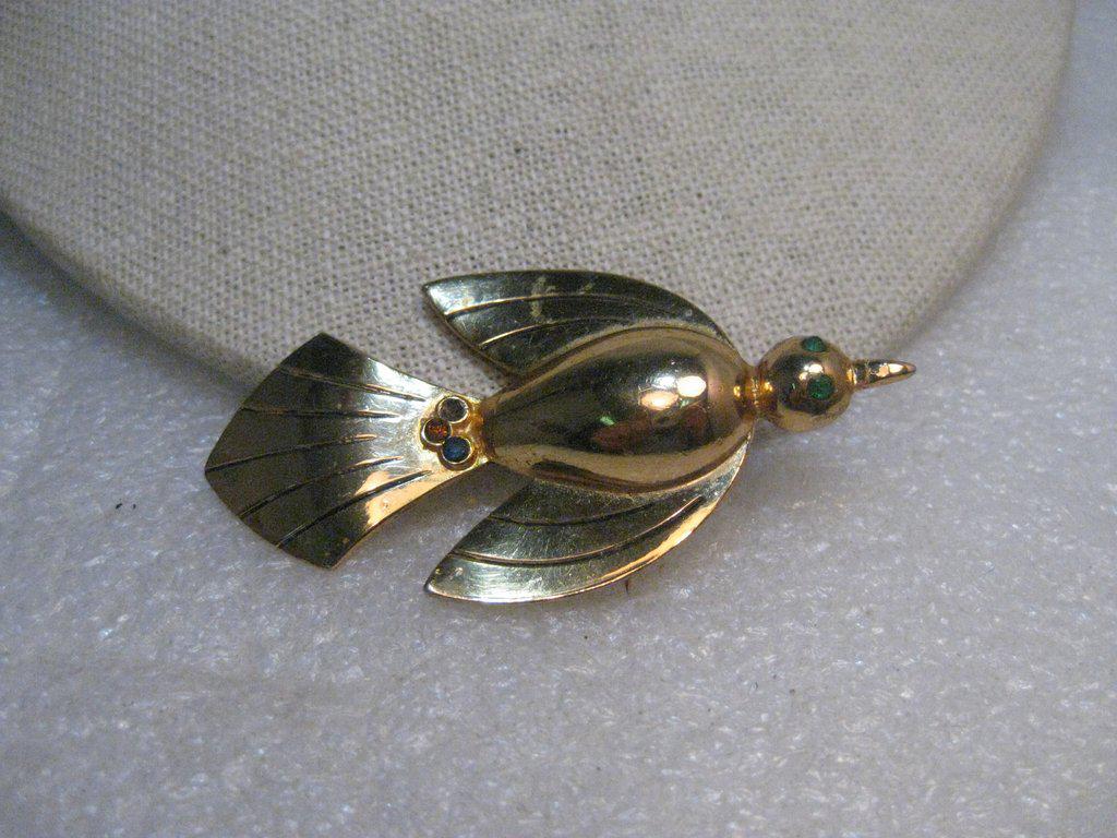 Vintage Coro Pegasus Bird Brooch, Rhinestones, 1960's,: Vintage Coro Pegasus Bird Brooch, Modern Design - in soaring position. 1960's. It has green rhinestone eyes and three small stones in the tail. It is 2.75" long and 1.5" wide, domed torso with grooved