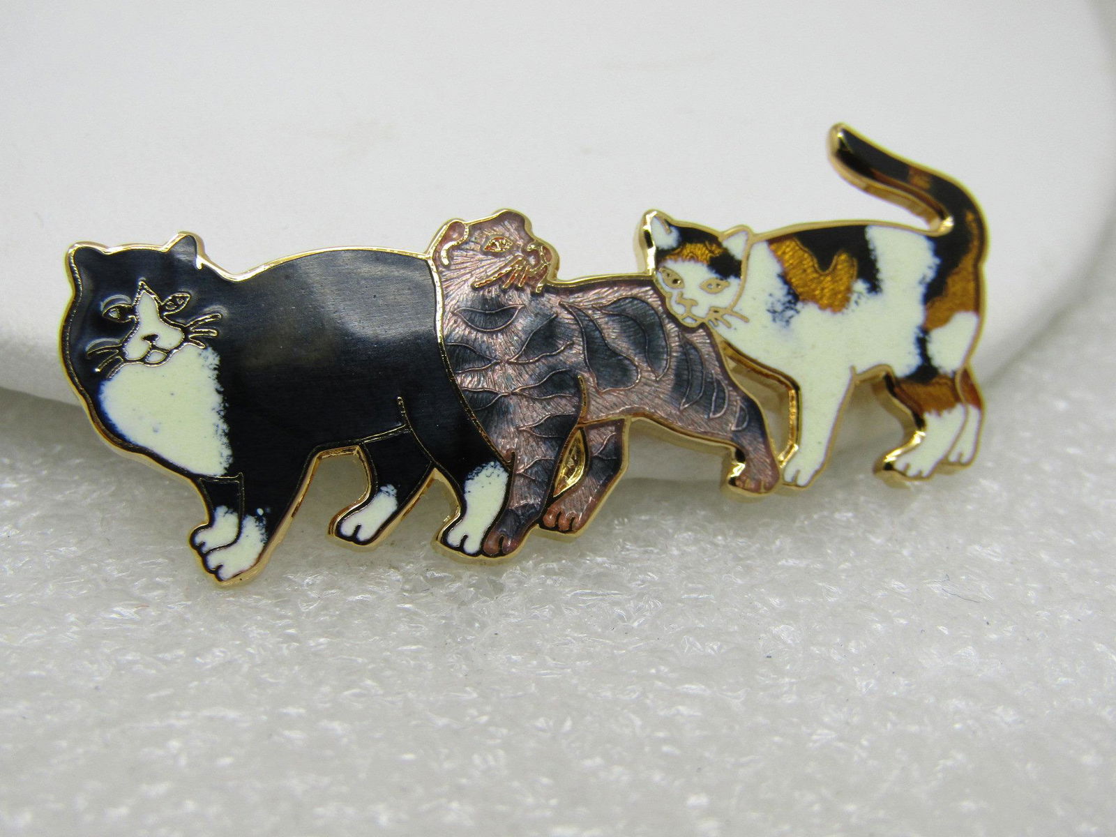 Vintage Cloisonne Cat Trio Brooch, Calico, Tabby,: Vintage Cloisonne Cat Trio Brooch, 2" long and 3/4" tall with a tuxedo, tabby, and calico cat. Signed with what looks like an odd shaped W or zig/zag pattern. Very cute brooch for the cat lover. In pe