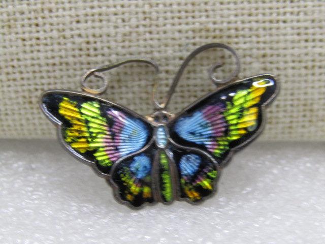 Vintage David Andersen Sterling Butterfly Brooch,: Vintage David Andersen Butterfly Brooch, sterling silver and signed - enameled brooch in blues, green, gold, pink with black background. Norway, 3.75gr. It is 1.25" wide and 1" tall. The one antenna h