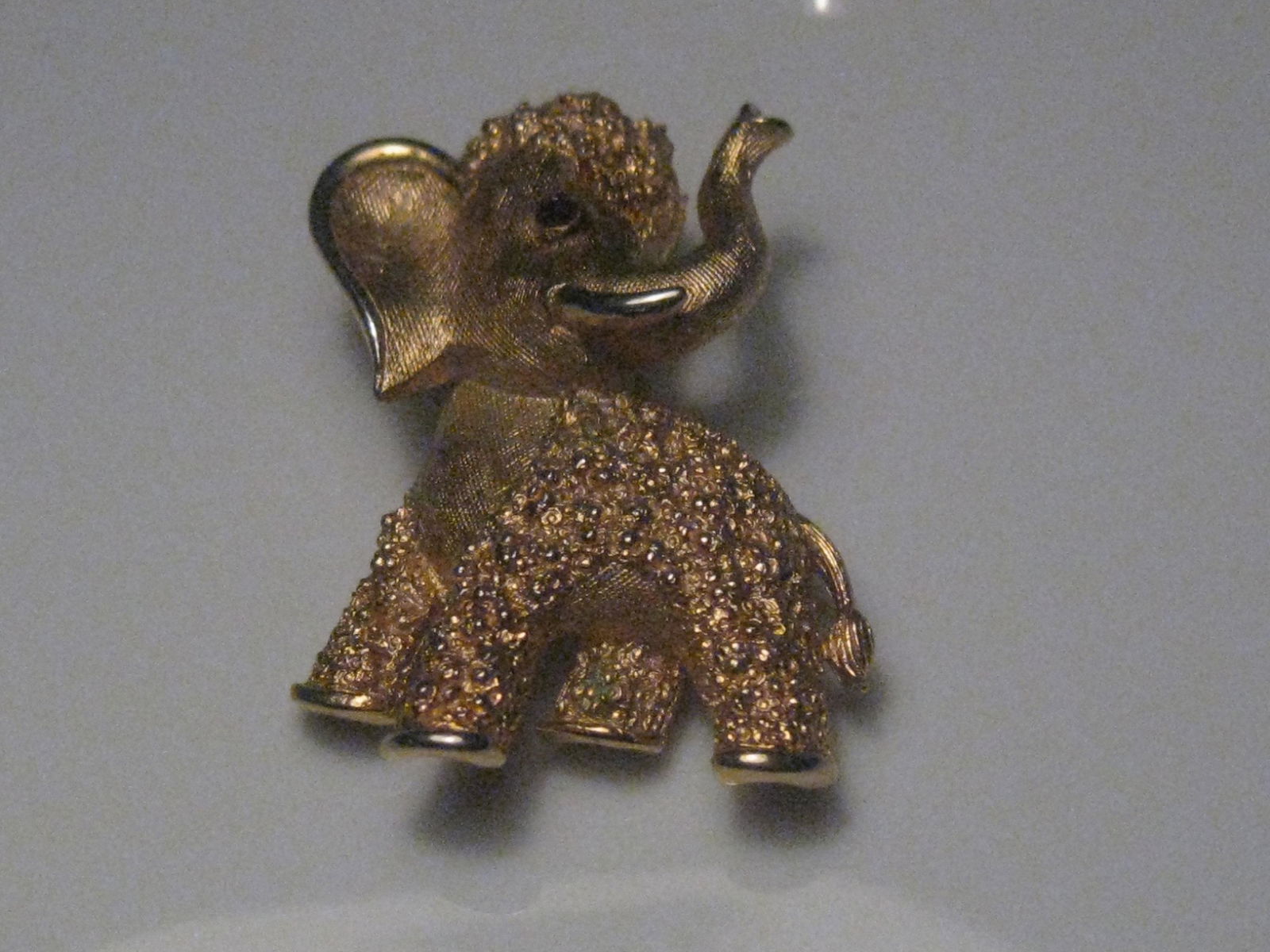 Vintage Crown Trifari Elephant Brooch, Red Eye, Wooly: Vintage Crown Trifari Elephant Brooch, Red Eye, Textured with wooly body and top of head - looks like a wooly mammoth. It is 1.25" tall and 1" wide. Cute red eye. It came from a PA estate. Very good c