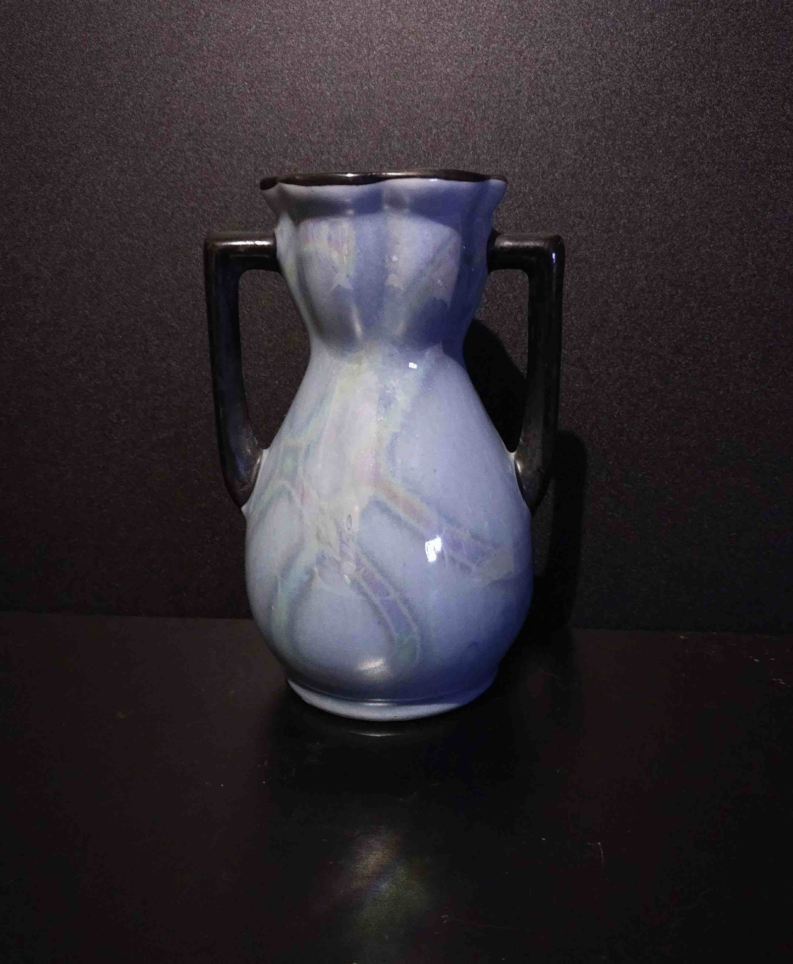 Blue Czechoslovakian Lusterware Bud Vase: Title: Blue Czechoslovakian Lusterware Bud Vase Description: Light blue luster glazed veramic bud vase. Black handle on either side. Made in Czechoslovakia. Date/Period: Materials: Clay Dimensions:5" 