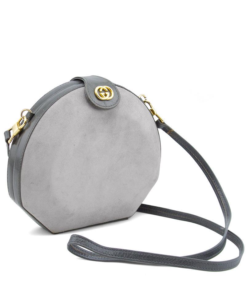 Gucci Grey Suede and Leather Clamshell Bag with: Unique 80s grey clamshell bag with a wonderful mix of finely grained leather and soft suede textures. Small top flap with GG medallion and snap covers the hinge frame which opens wide to reveal an bla