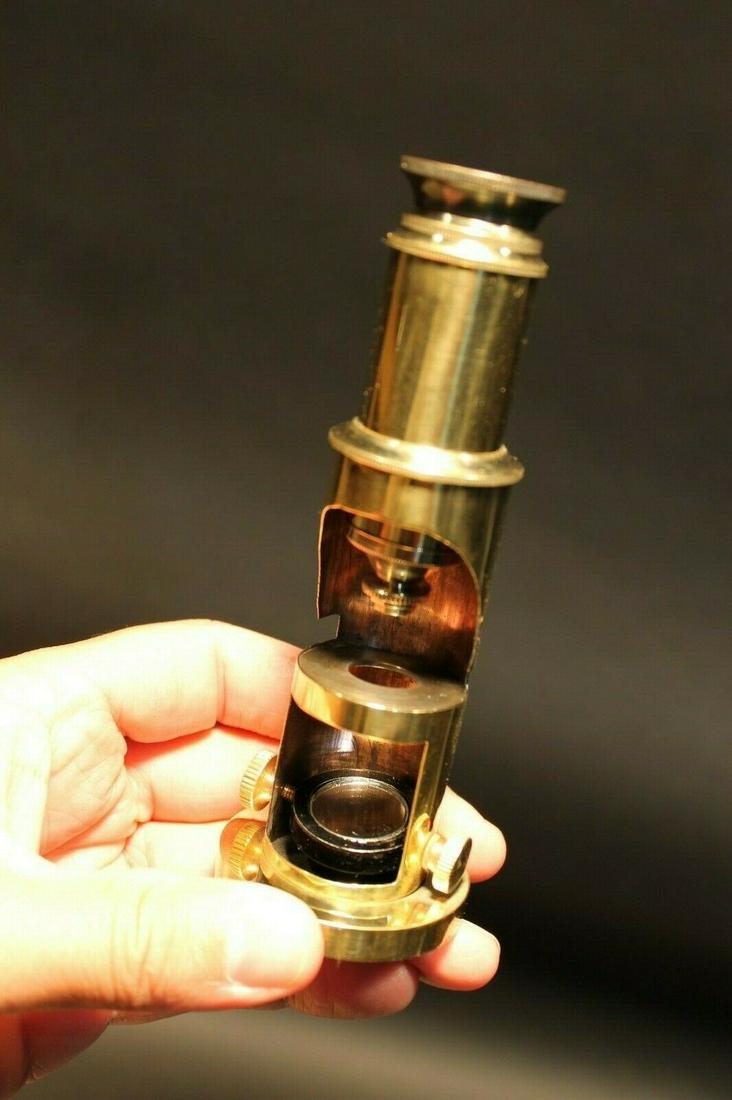 Brass Portable Microscope: 5 1/4" Tall 8" tall extended Such a neat reproduction antique microscope! This is made to look like one of the vintage portable microscopes used in field work. As shown in the images it telescopes up 