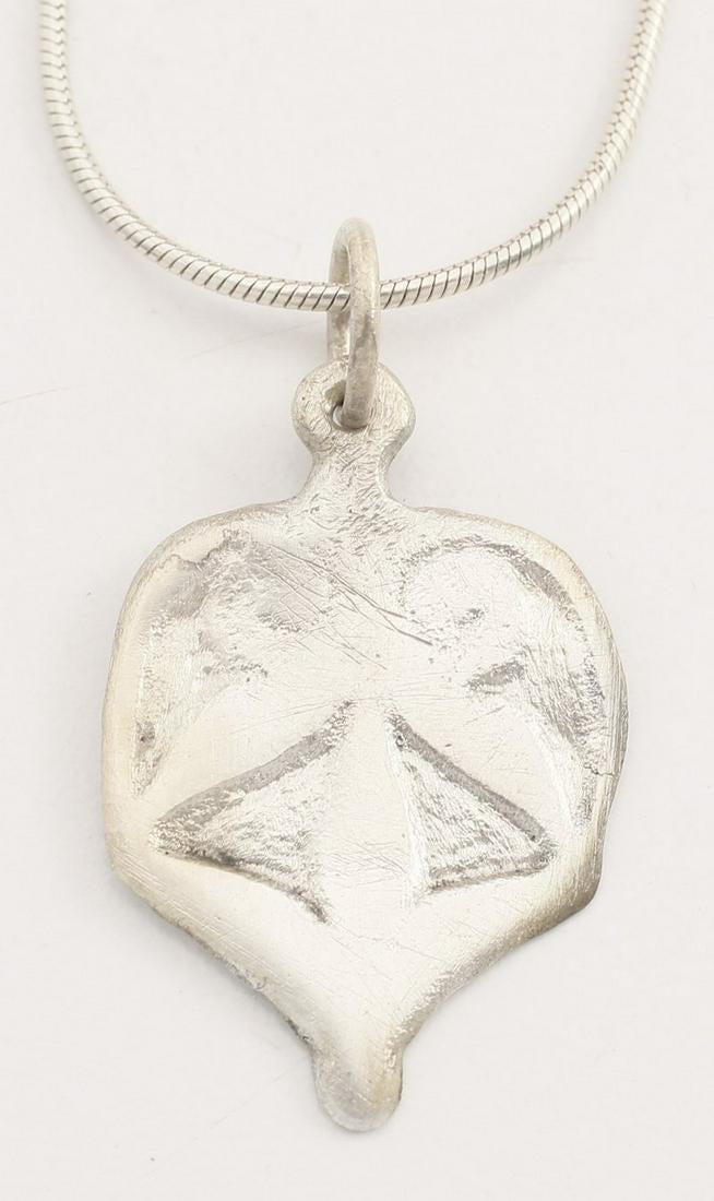 VIKING HEART PENDANT C.10TH-11TH CENTURY AD: Large example 1” height of broad form with raised edge and scroll top trefoil central motif. The bottom with w pendular nub. Made by the open face mold technique. Fully developed for with cusped top