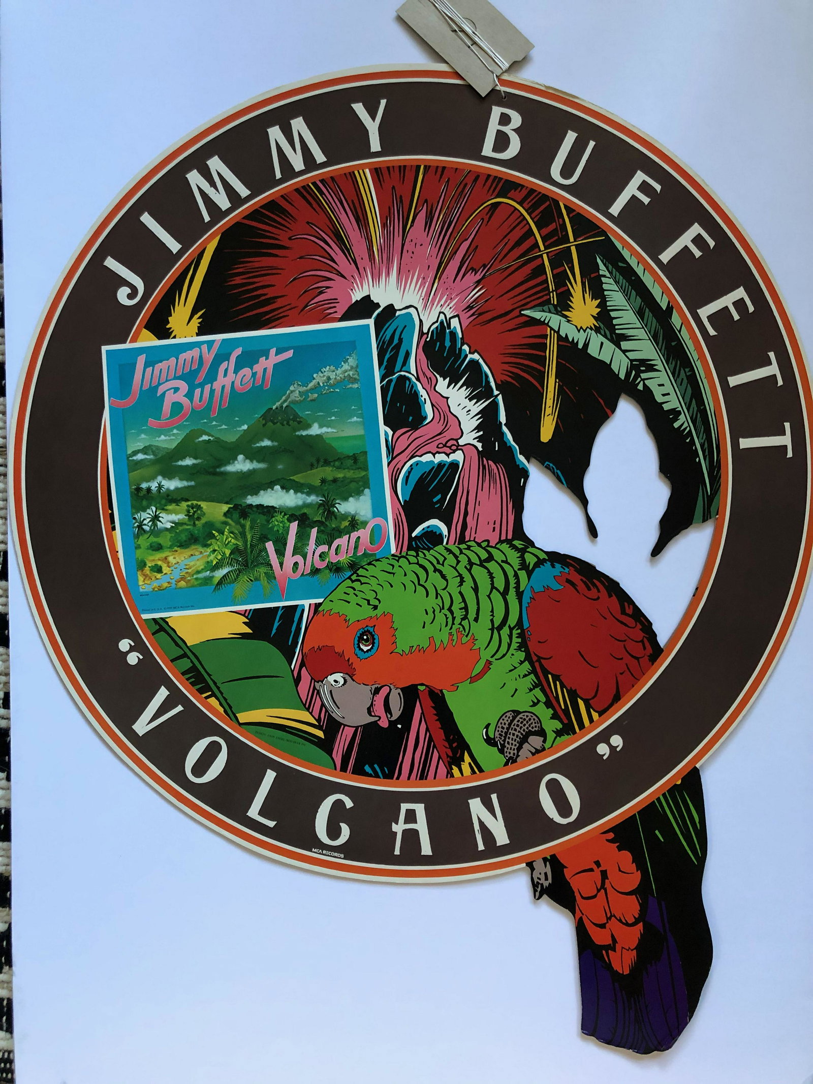 VERY RARE JIMMY BUFFETT PROMO: VERY RARE JIMMY BUFFETT PROMO - hard cardboard hanging mobile used at records stores to promote the Volcano album release. Huge hangning promo about 24 " round. 1979 by MCA Records. Design by Andy Eng