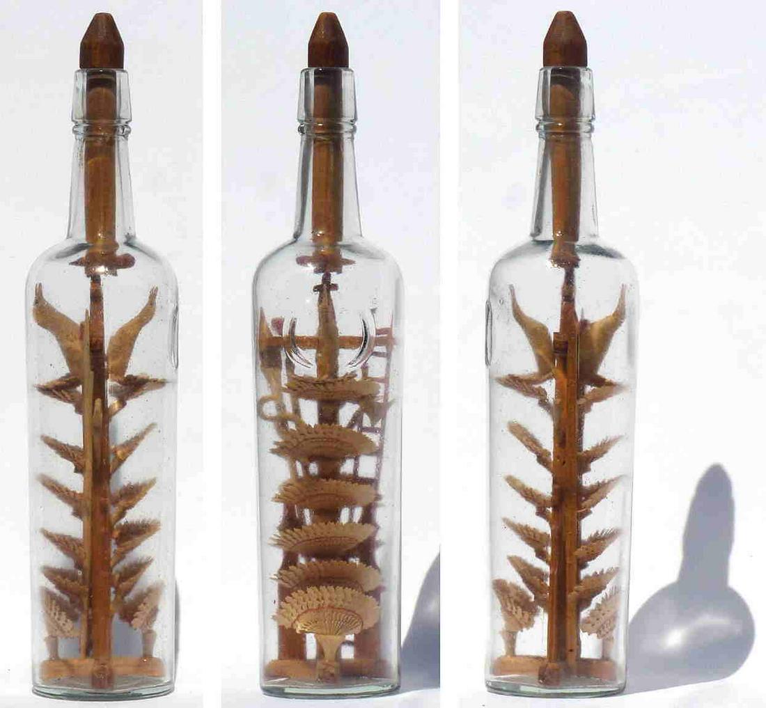 An intricate bottle whimsy containing 12 carved fans (1 of 7)